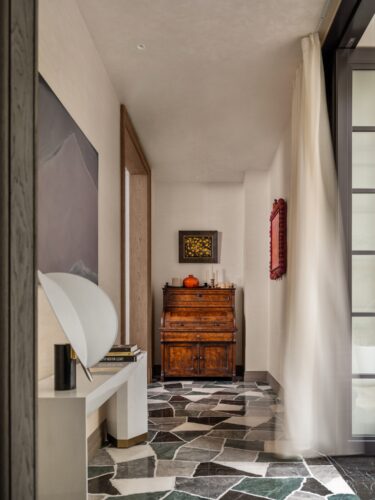 An antique cabinet in the distance — part of a private collection — stands alongside floral vessels by Alexander Lamont, while Liu Manwen's Points, Lines and Planes Related to Nature (2023) animates the wall behind.